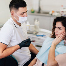 Are There Any Specific Symptoms That Indicate a Dry Socket, and How Is It Treated?